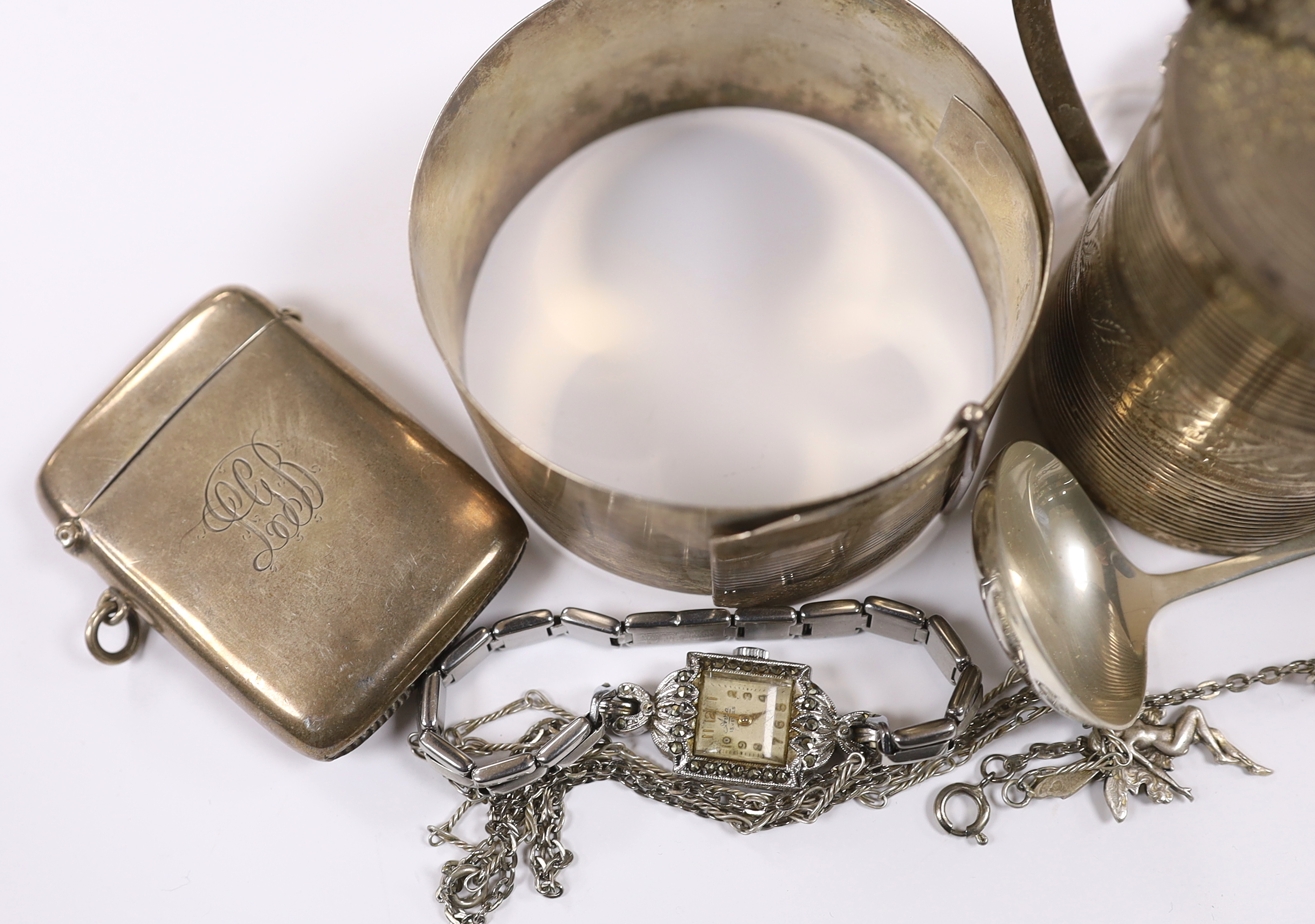 A small group of sterling or white metal jewellery, including a sterling bangle, together with a George III reeded silver mustard pot, London, 1802, silver vesta case and a silver ladle.